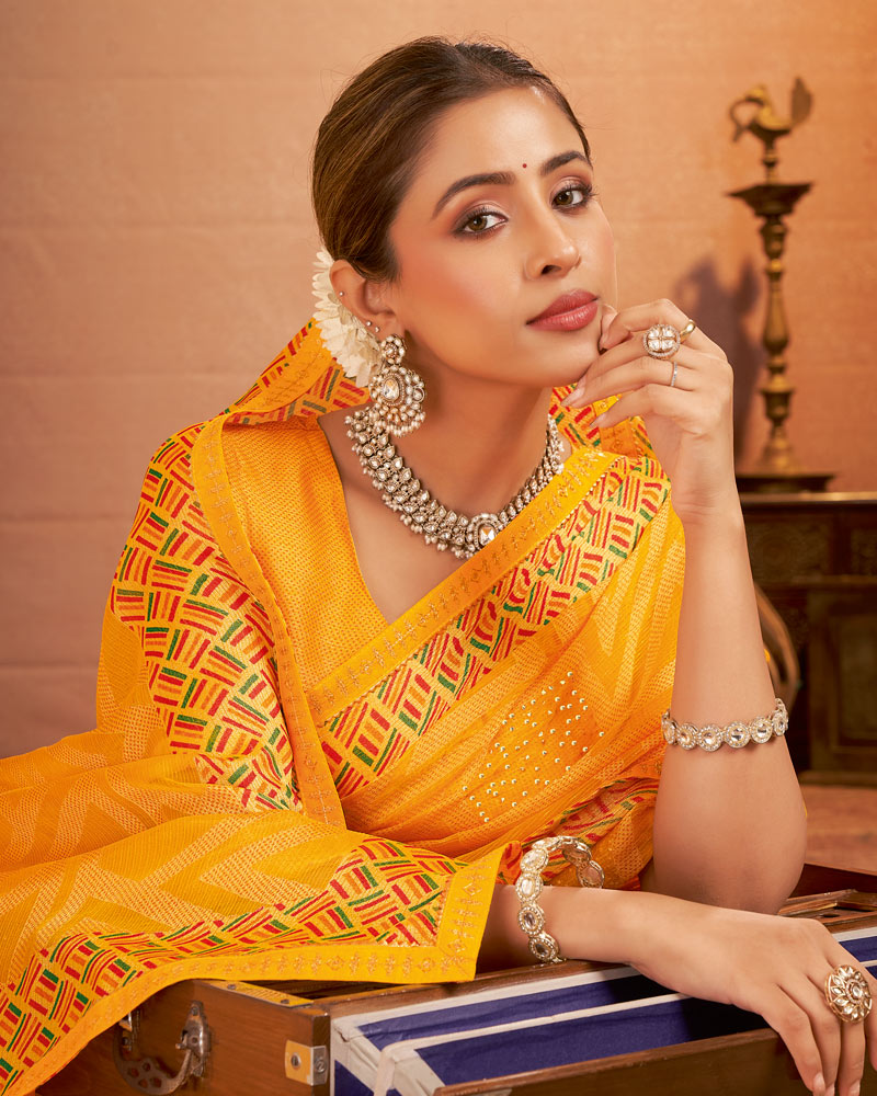Vishal Prints Yellowish Orange Printed Brasso Saree With Diamond Work And Fancy Border