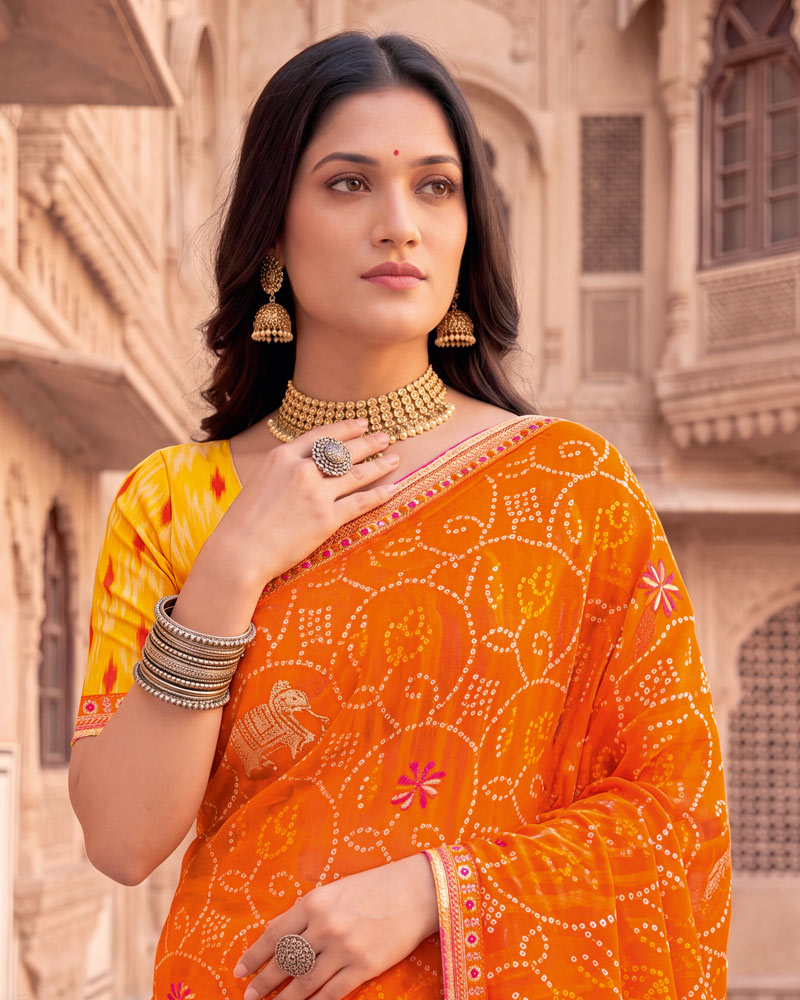 Vishal Prints Bright Orange Patterned Chiffon Traditional Print Saree With Foil Print And Fancy Embroidery Border