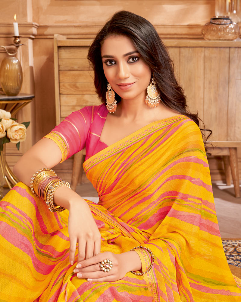 Vishal Prints Orangey Yellow Printed Brasso Saree With Fancy Border