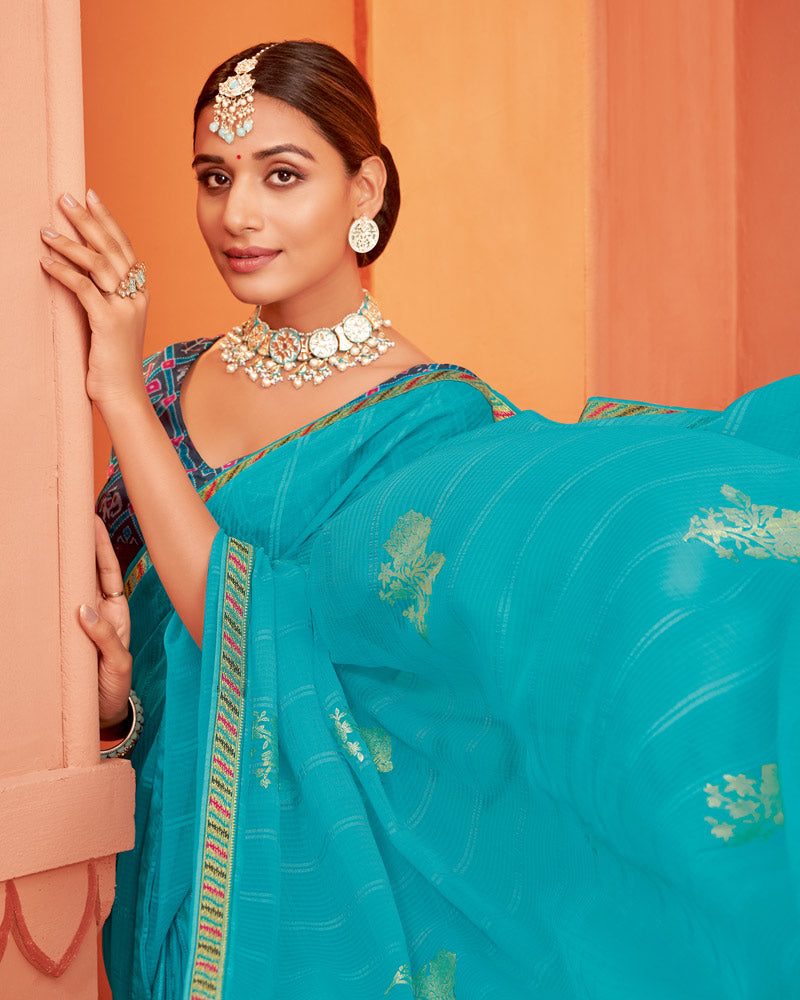 Vishal Prints Dark Turquoise Blue Patterned Chiffon Saree With Foil Print And Zari Border